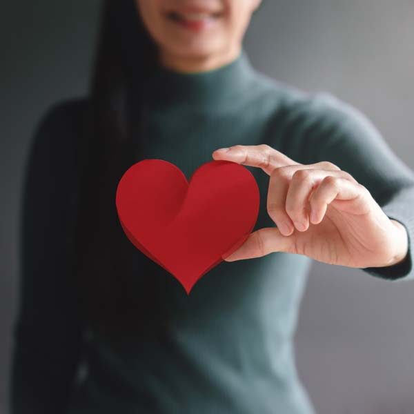 Woman holding paper heart